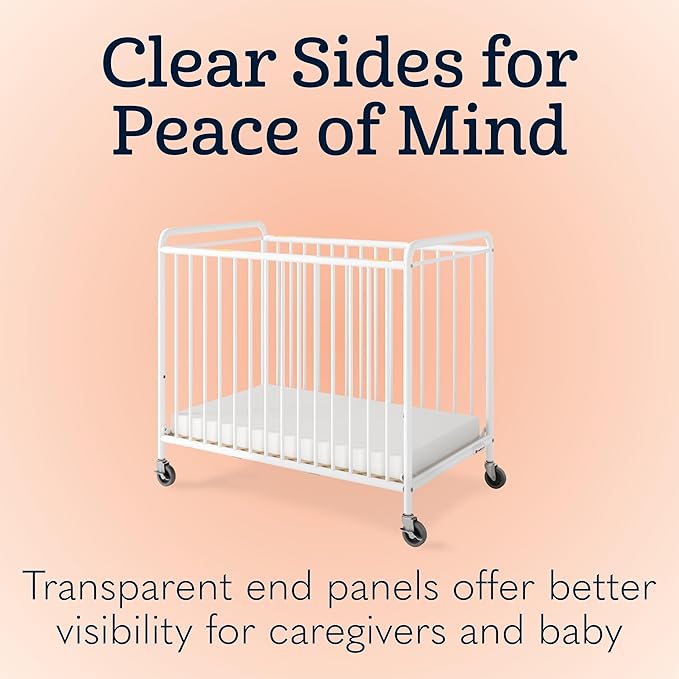 Foundations Chelsea Clearview Metal Compact Daycare Crib, 3" Casters, Compact Mini Size, Easy to Clean Durable Finish, Adjustable to Two Heights Mattress Board (White)